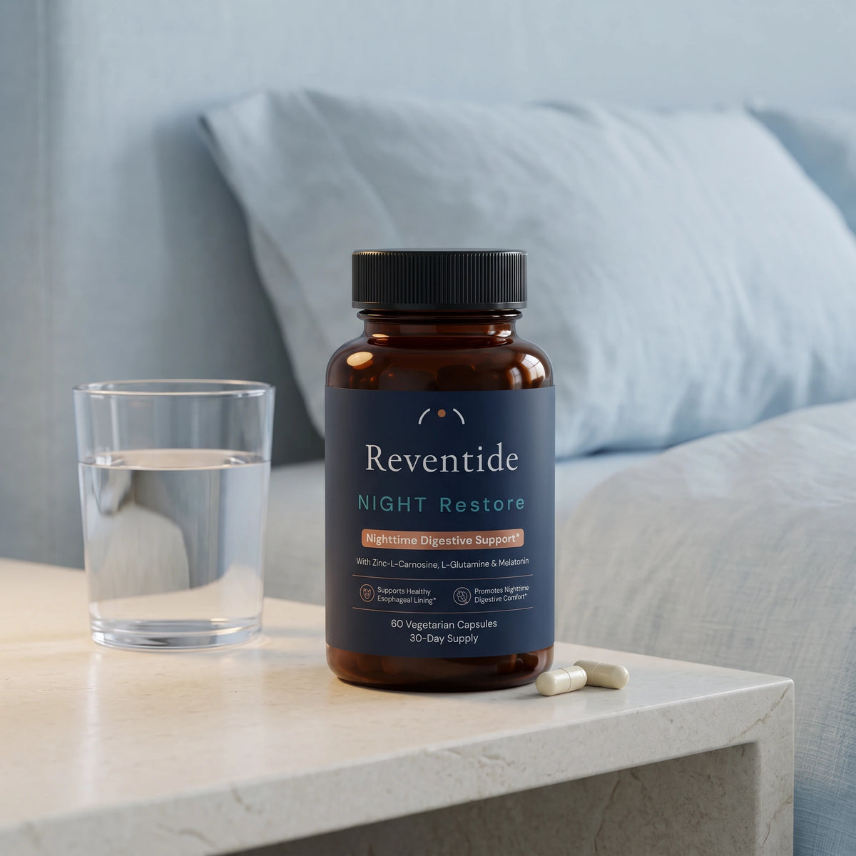 NIGHT Restore beside water and two capsules on a bedside table